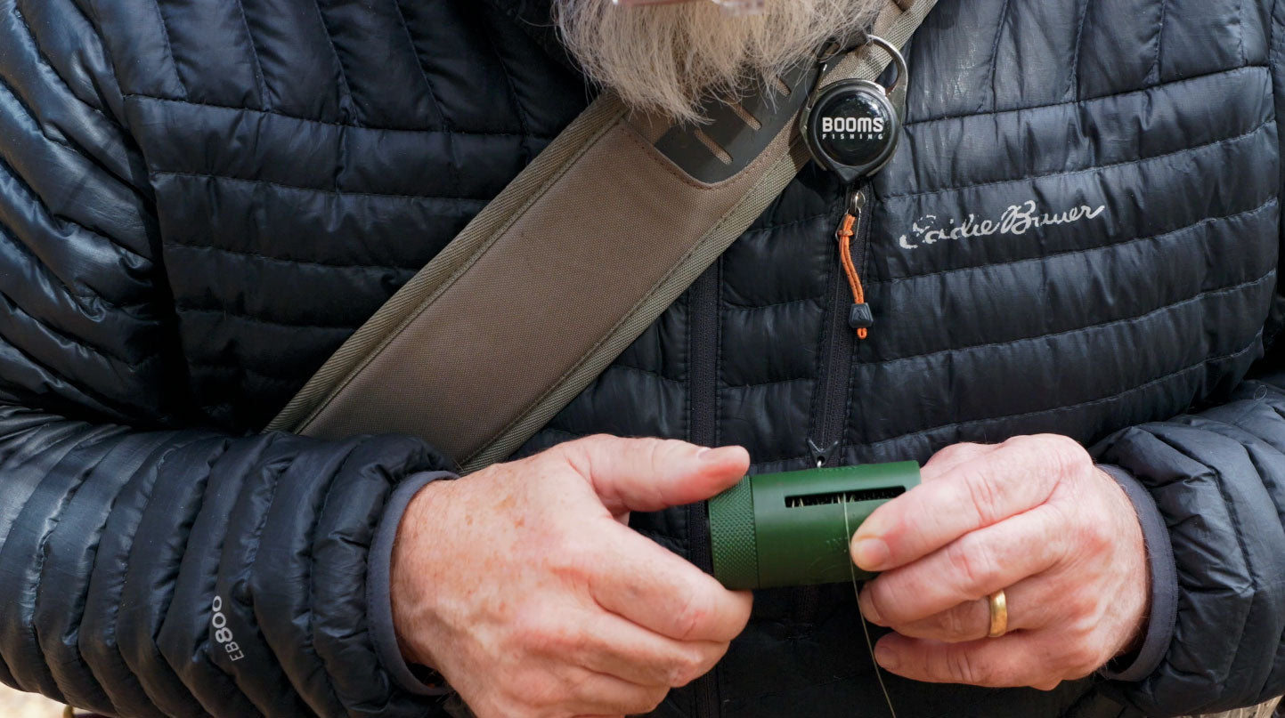 Angler in the field holding the Leader Eater Mini, ready to pack out fishing line