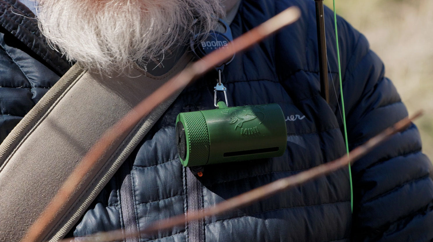 Angler feeding leader line into the Leader Eater Mini while fly fishing